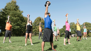 People lifting kettlebells outdoors