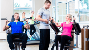 A personal trainer giving some instructions to people working out
