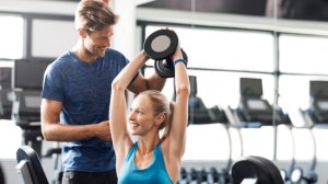 A woman lifting a dumbbell while sitting
