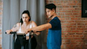 A fat lady doing workout with a personal trainer help