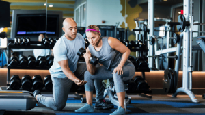 A woman lifting dumbbell with one hand