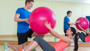 A woman doing workout with a big exercise ball